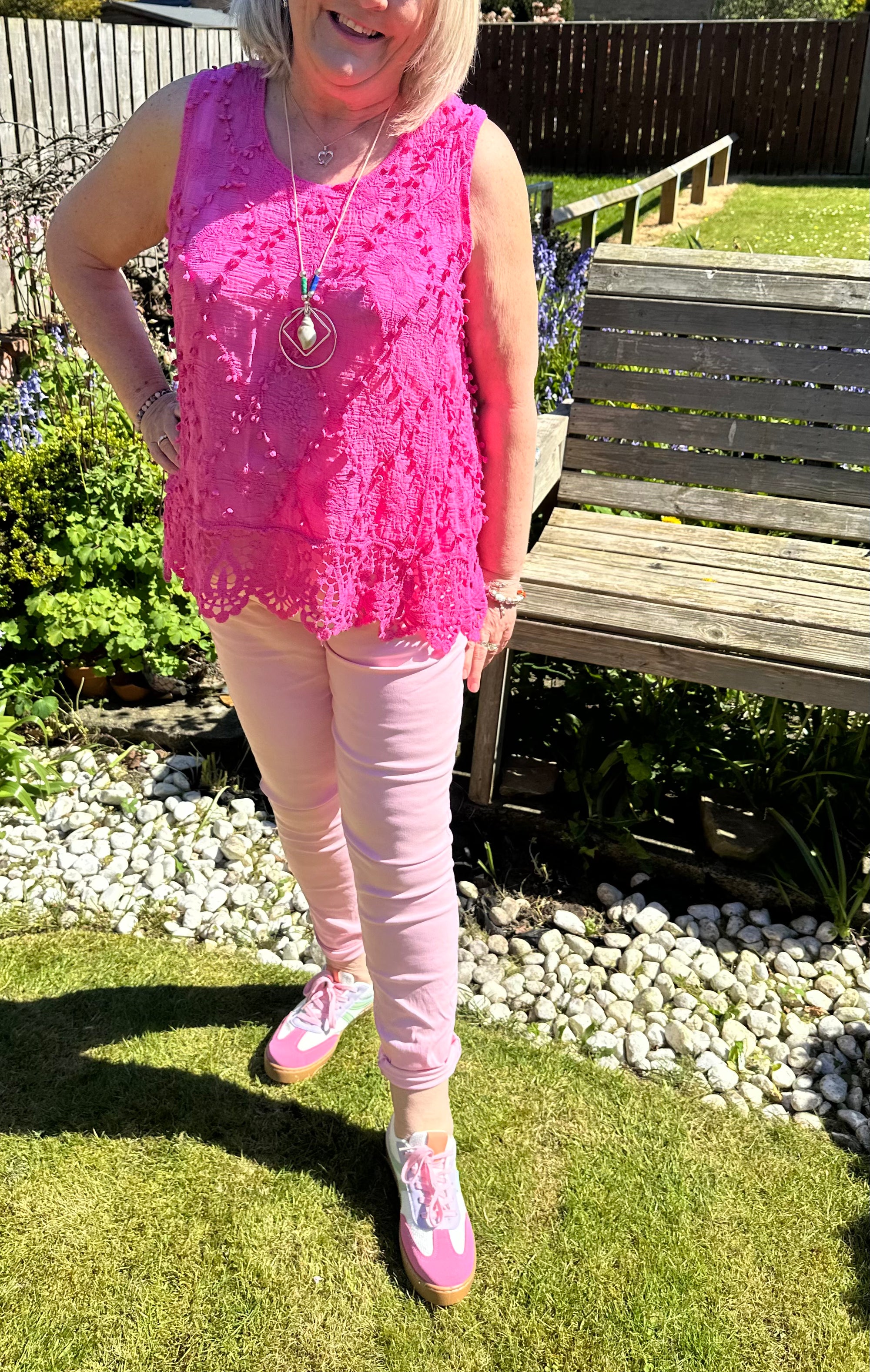 Saffron embroidered appliqué pom pom top with crochet hem. 10-18