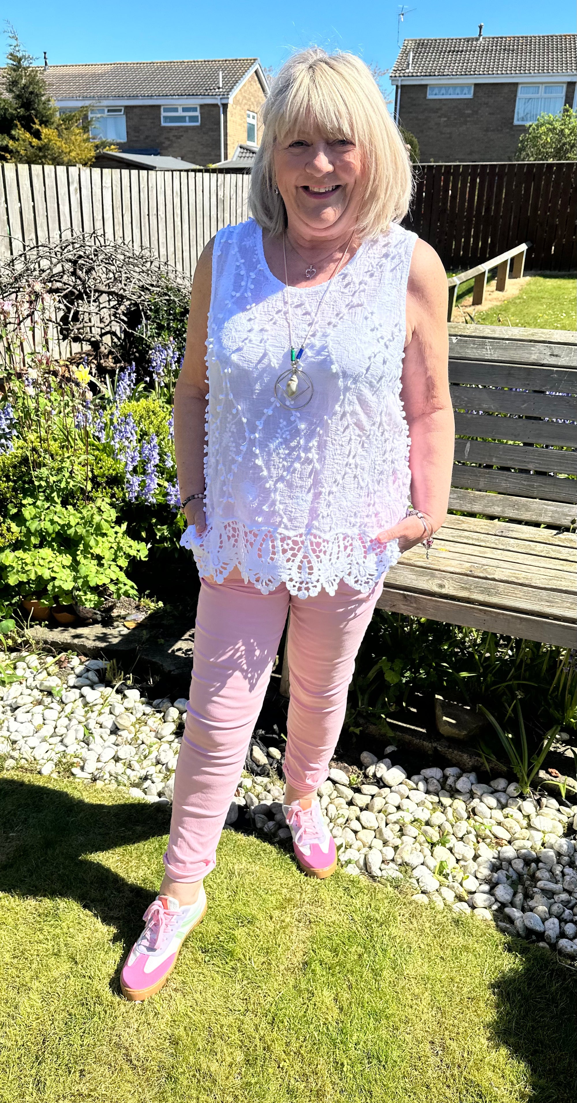 Saffron embroidered appliqué pom pom top with crochet hem. 10-18