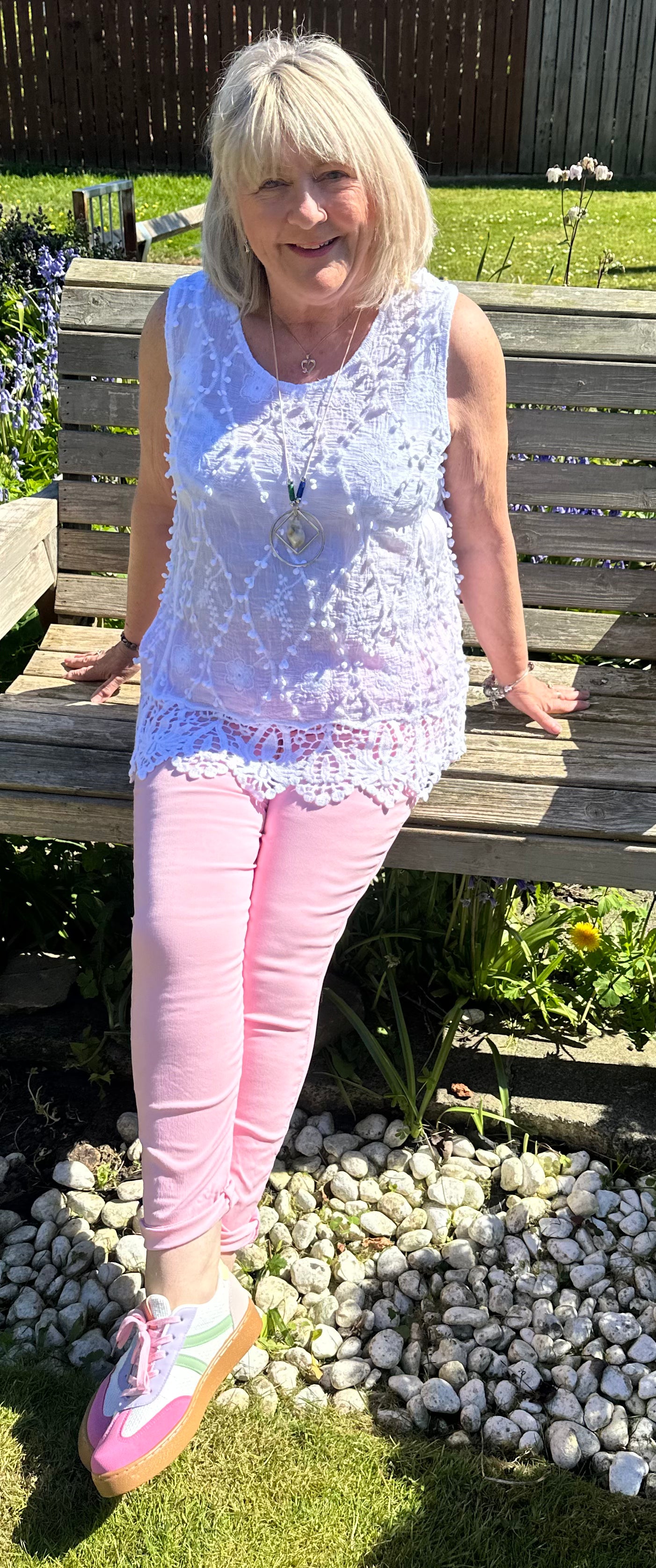Saffron embroidered appliqué pom pom top with crochet hem. 10-18