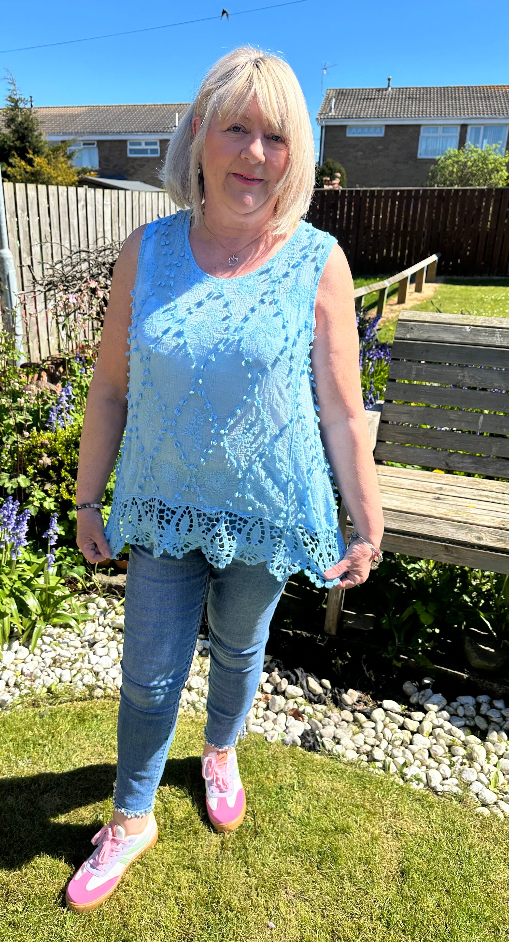 Saffron embroidered appliqué pom pom top with crochet hem. 10-18