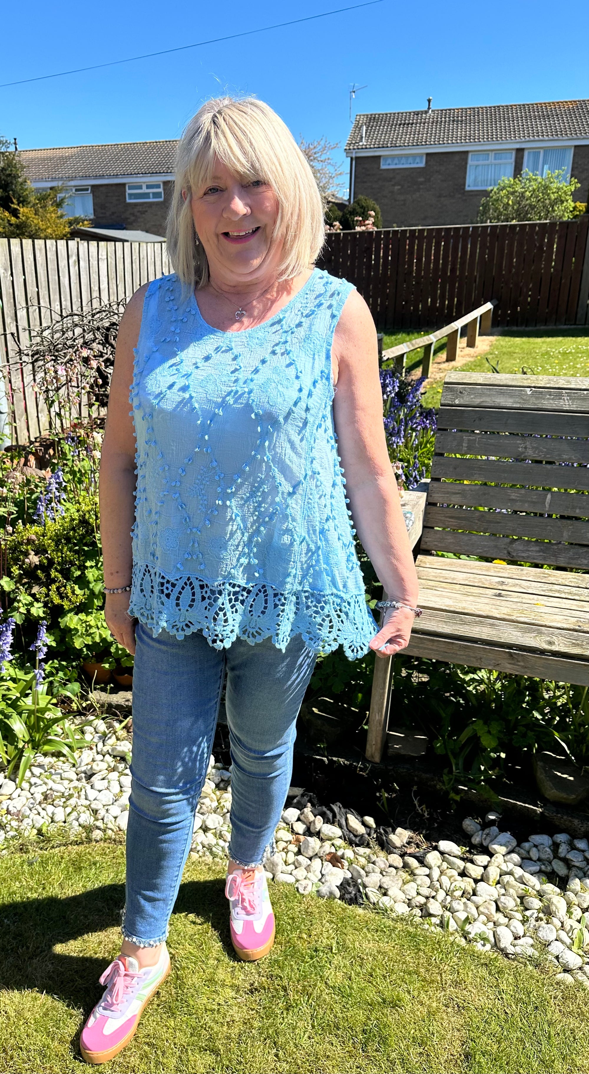 Saffron embroidered appliqué pom pom top with crochet hem. 10-18