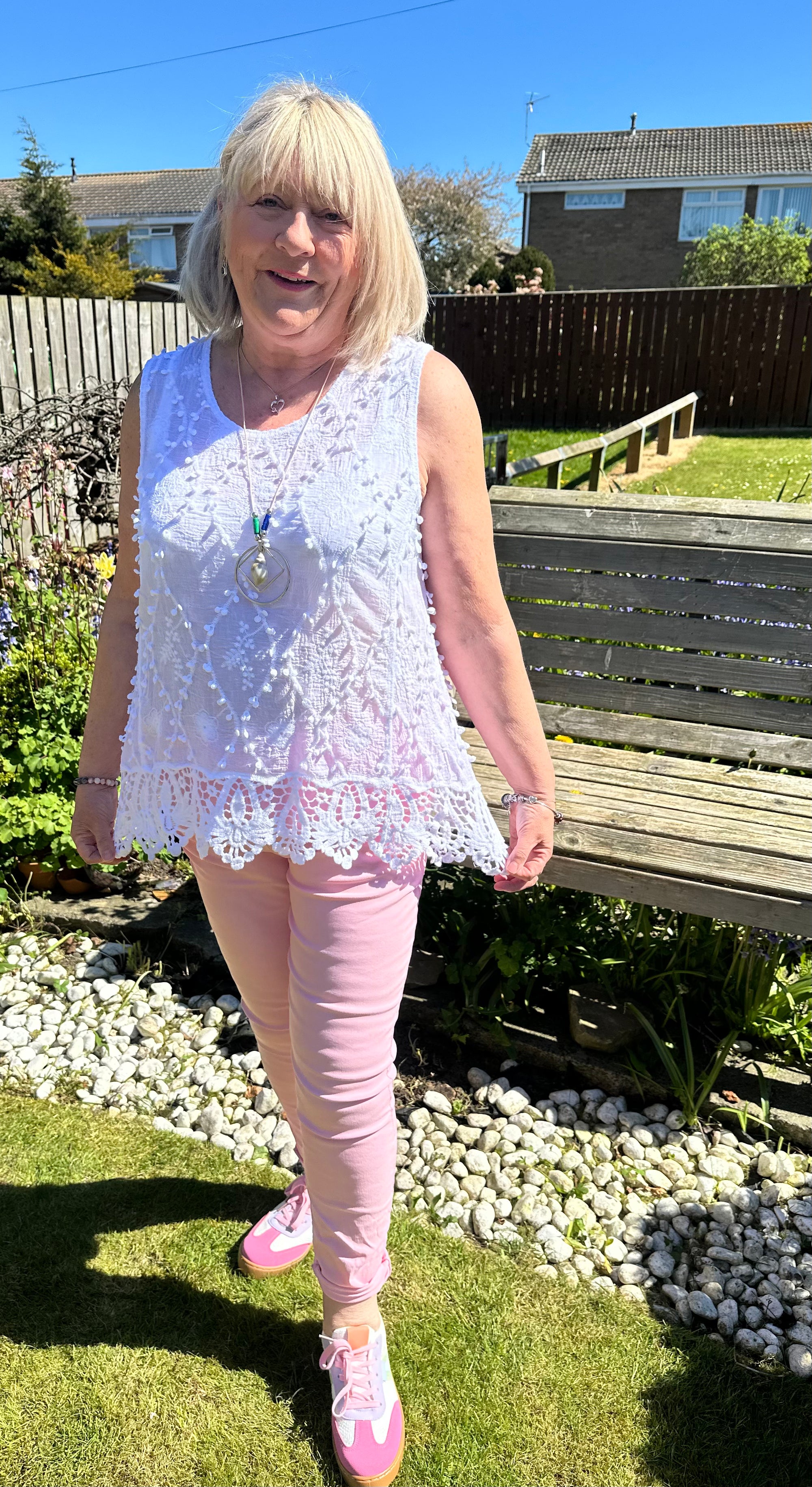 Saffron embroidered appliqué pom pom top with crochet hem. 10-18