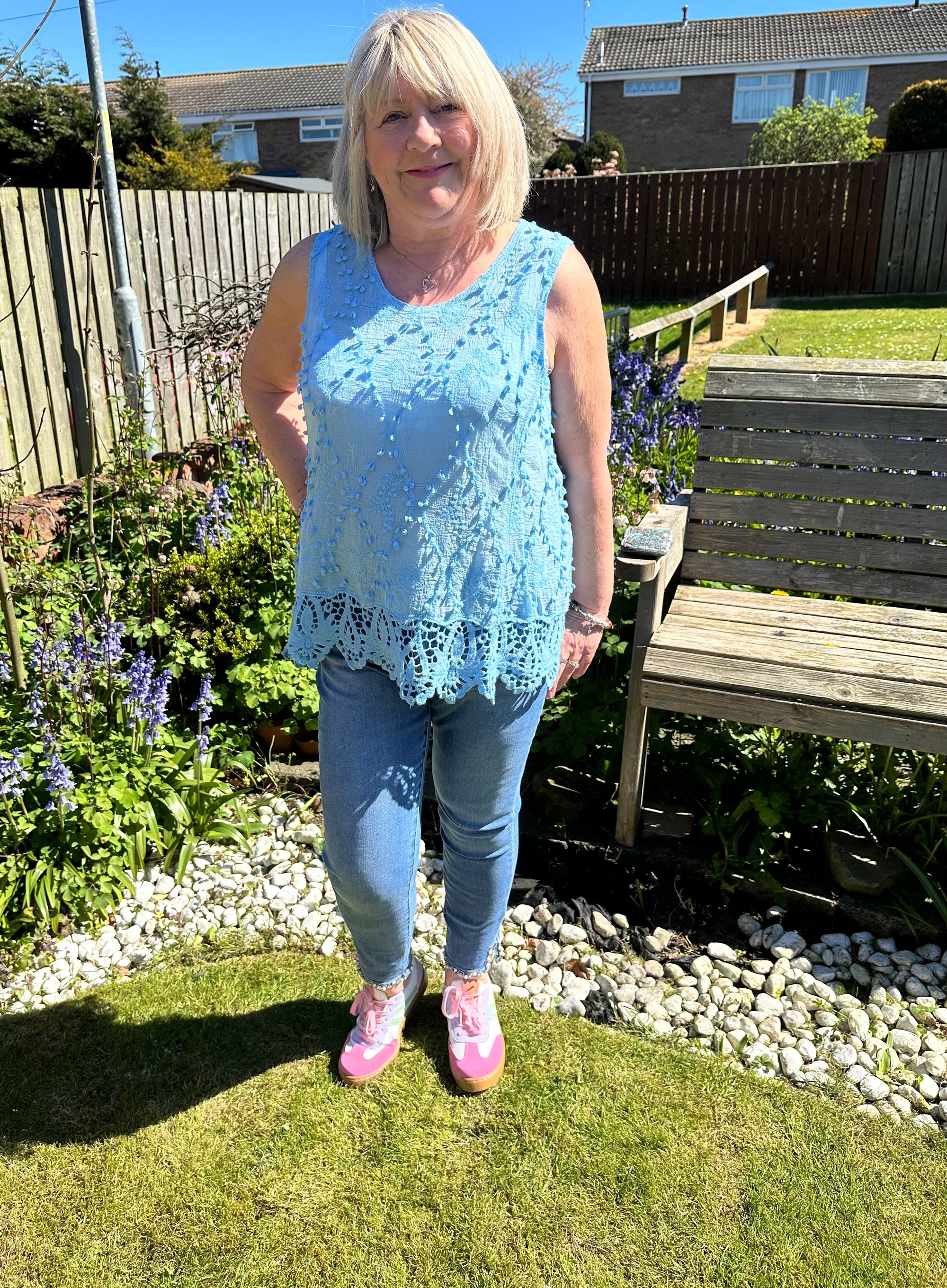 Saffron embroidered appliqué pom pom top with crochet hem. 10-18
