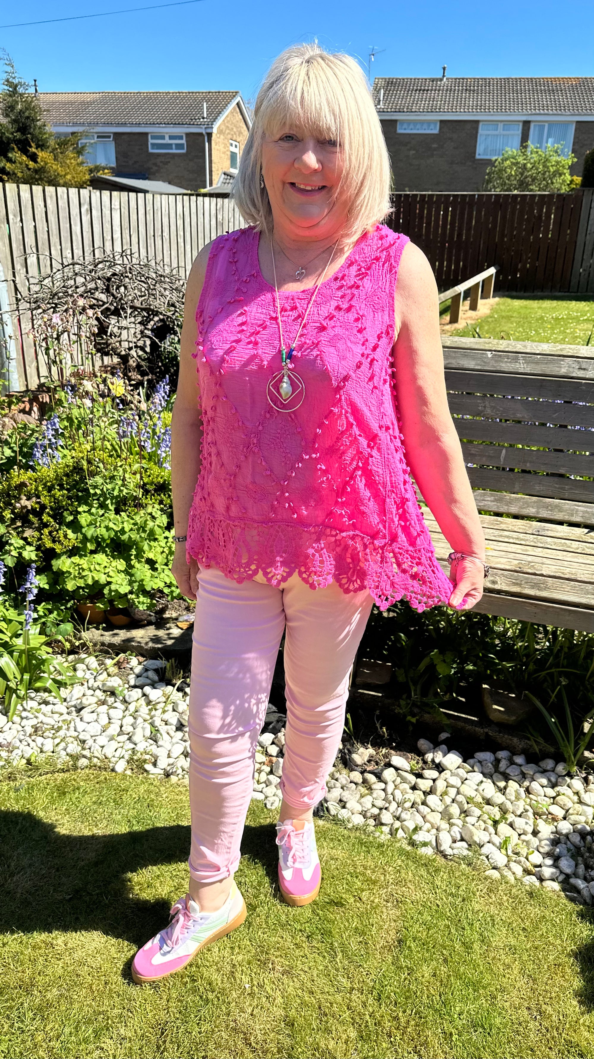 Saffron embroidered appliqué pom pom top with crochet hem. 10-18
