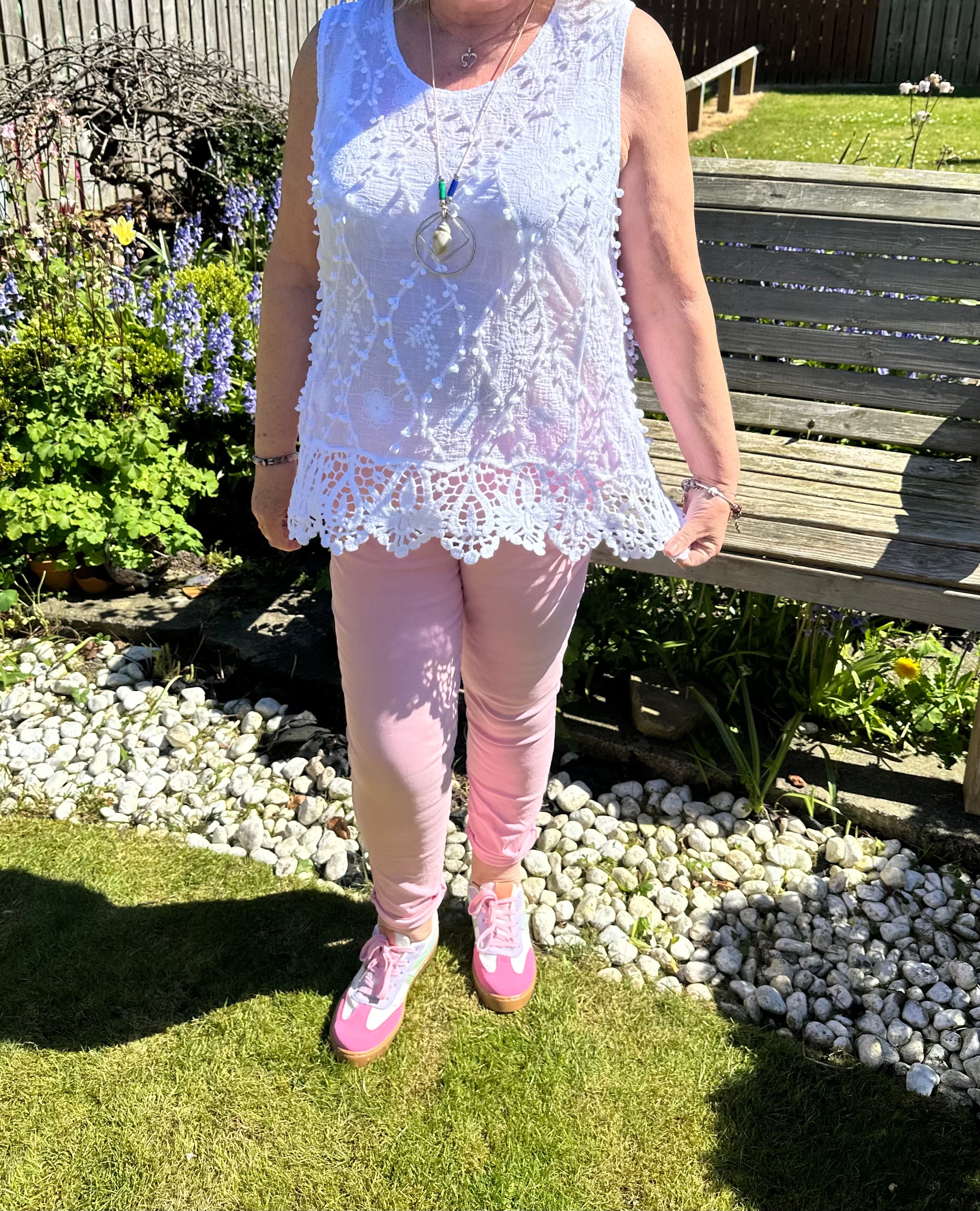 Saffron embroidered appliqué pom pom top with crochet hem. 10-18